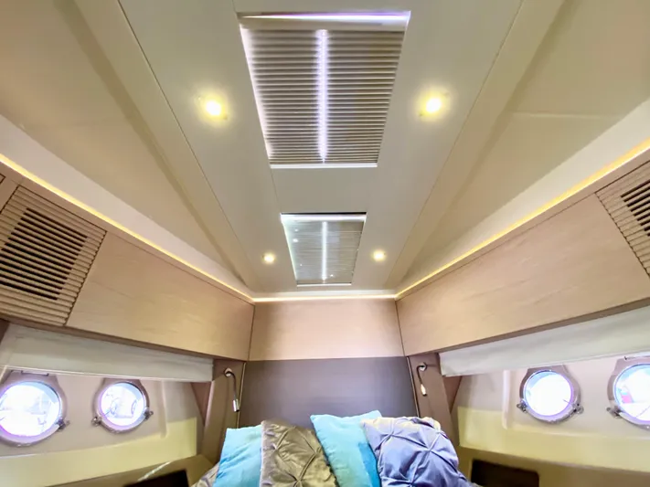 Revenant Yacht Photos Pics Luxurious 2015 Monte Carlo MC5S yacht cabin interior with skylights and portholes.