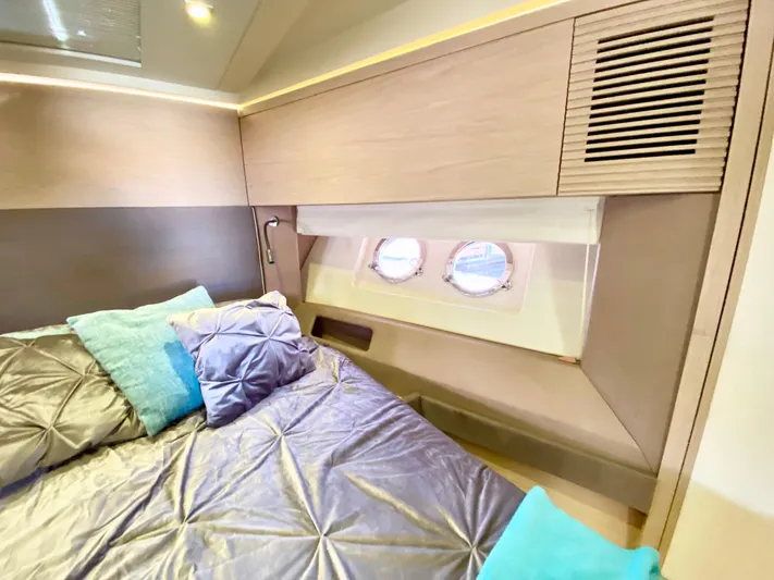 Revenant Yacht Photos Pics Luxurious bedroom interior of 2015 Monte Carlo MC5S yacht with elegant bedding and porthole windows.