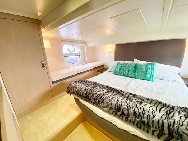 Revenant Yacht Photos Pics Luxurious bedroom interior of 2015 Monte Carlo MC5S yacht with modern design and cozy bedding.