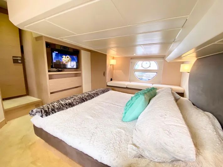 Revenant Yacht Photos Pics Luxurious 2015 Monte Carlo MC5S yacht bedroom with modern decor and circular window view.