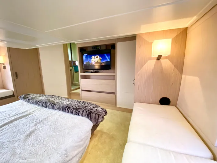 Revenant Yacht Photos Pics Luxurious 2015 Monte Carlo MC5S yacht bedroom with TV, cozy bed, and modern lighting.