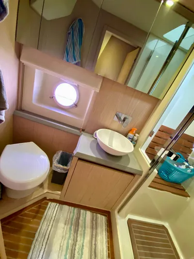 Revenant Yacht Photos Pics Luxurious 2015 Monte Carlo MC5S yacht bathroom with modern fixtures and porthole window.