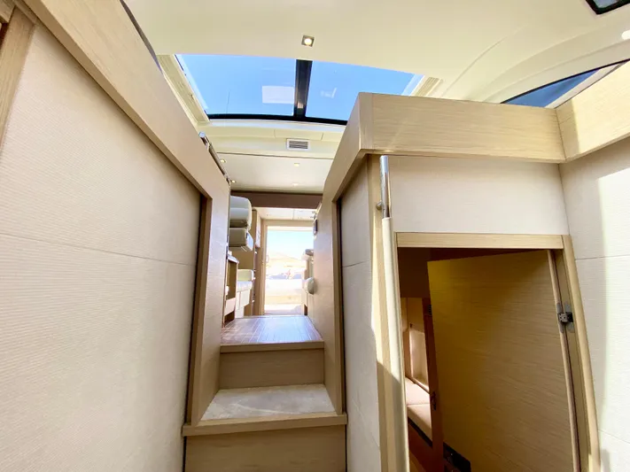 Revenant Yacht Photos Pics Interior of 2015 Monte Carlo MC5S yacht with skylight and modern wooden design.