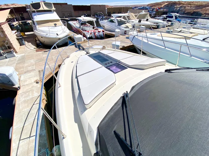 Revenant Yacht Photos Pics 2015 Monte Carlo MC5S yacht docked among other boats in a marina.