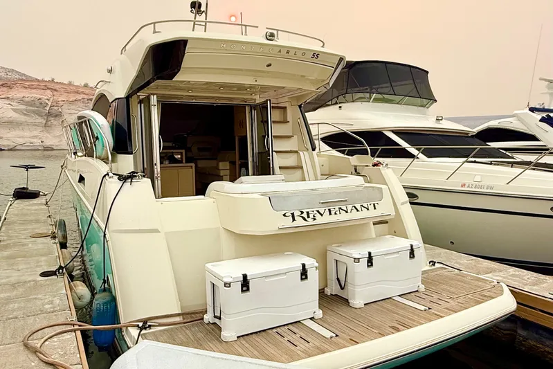 Revenant Yacht Photos Pics Luxury Monte Carlo MC5S yacht docked, 2015 model, with open deck and scenic backdrop.