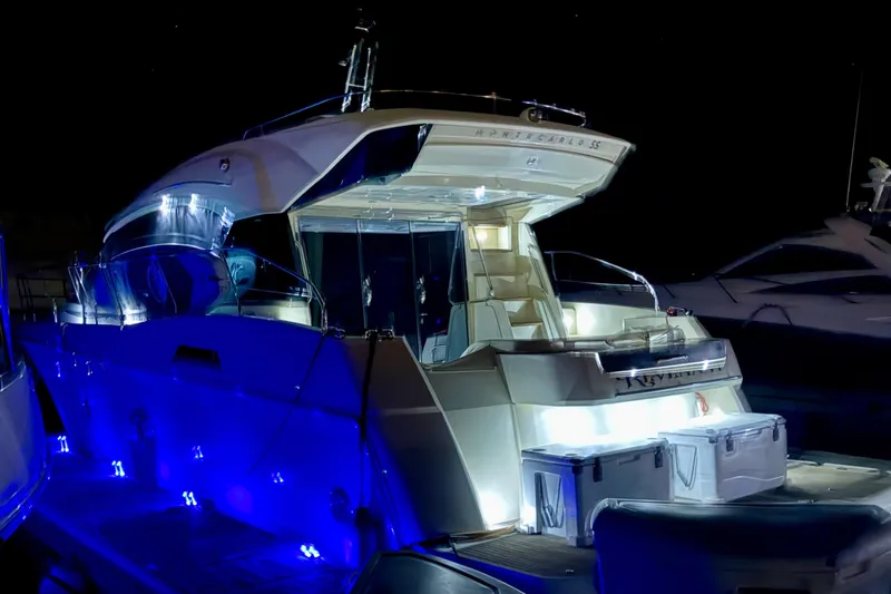 Revenant Yacht Photos Pics Luxurious 2015 Monte Carlo MC5S yacht illuminated at night with blue LED lights.