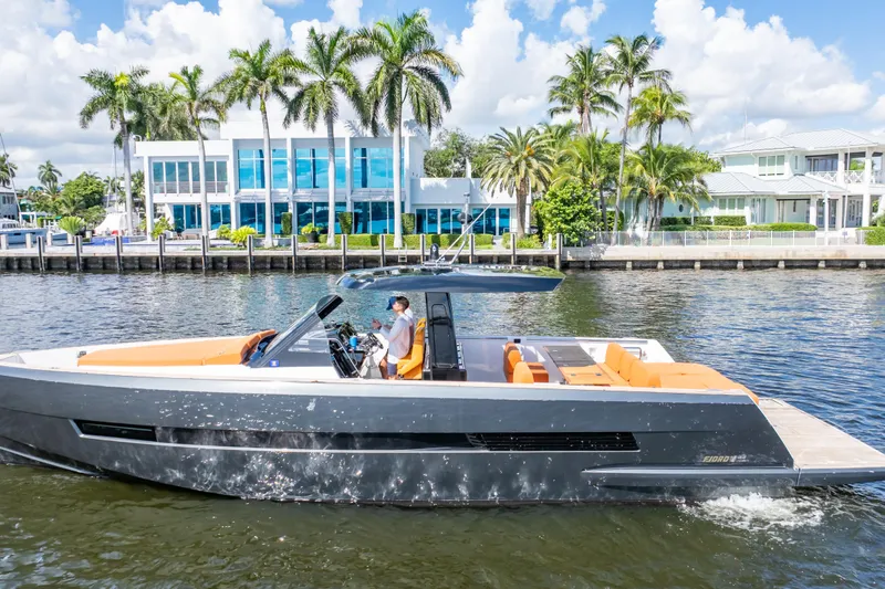  Yacht Photos Pics 2020 Fjord 44 Open yacht cruising near waterfront homes with palm trees.