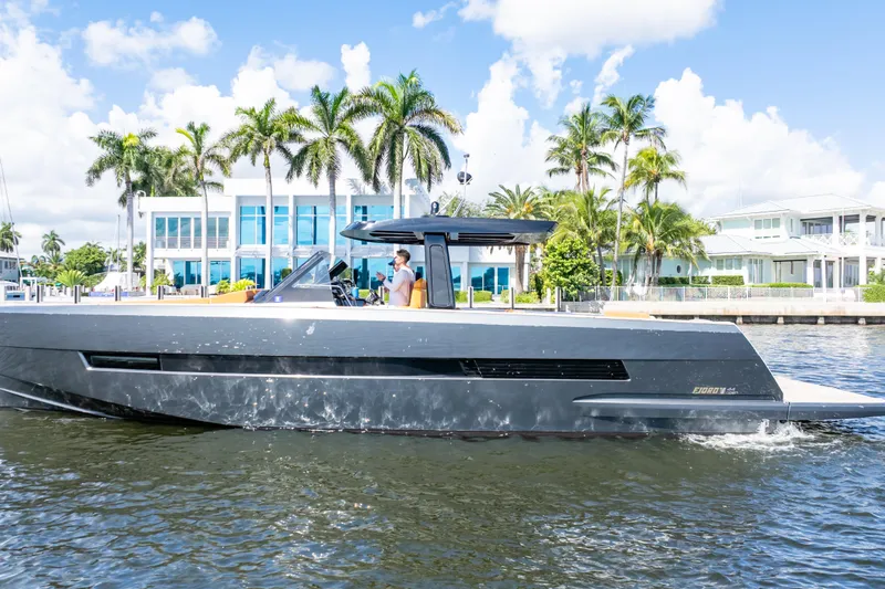  Yacht Photos Pics 2020 Fjord 44 Open yacht cruising near waterfront homes with palm trees.