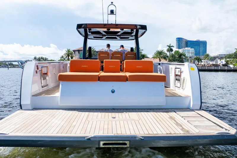  Yacht Photos Pics 2020 Fjord 44 Open yacht with orange seating, docked on a sunny waterfront.