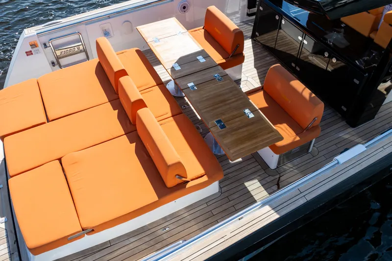  Yacht Photos Pics Luxurious 2020 Fjord 44 Open yacht with orange seating and wooden deck table.