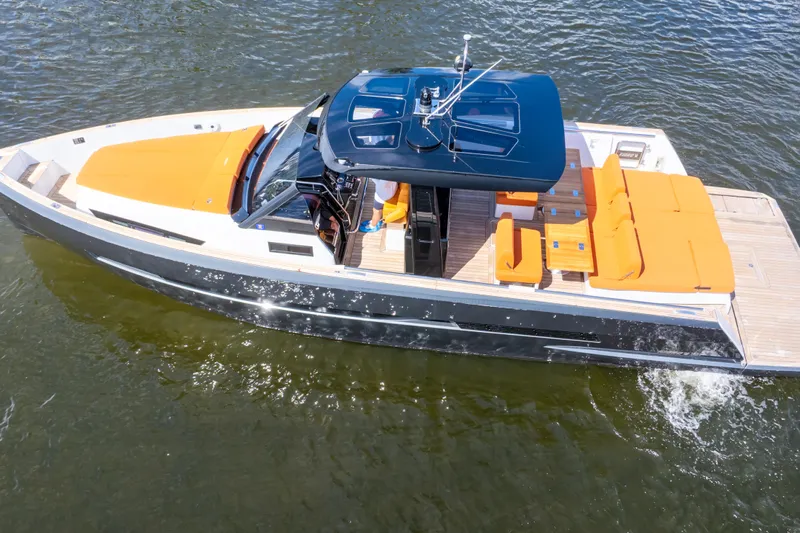  Yacht Photos Pics 2020 Fjord 44 Open yacht with orange seating, cruising on water.