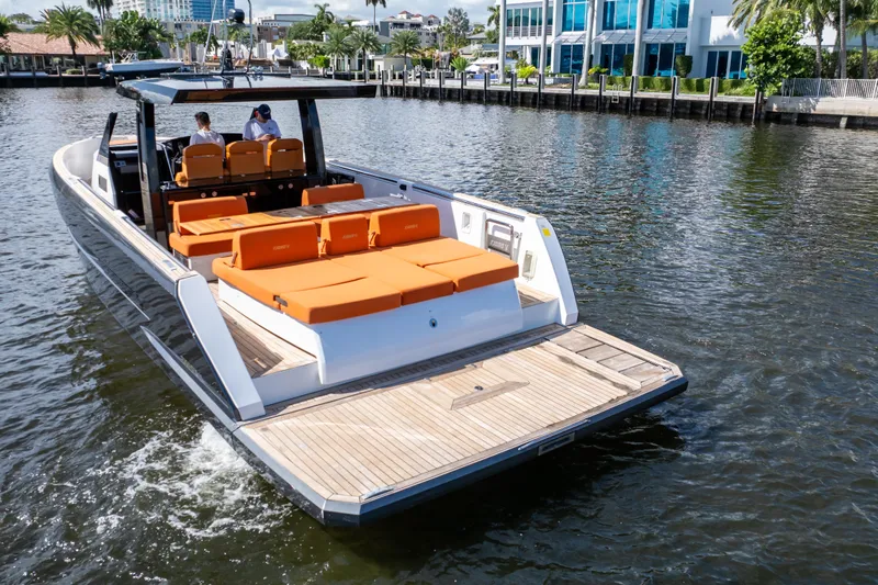  Yacht Photos Pics 2020 Fjord 44 Open yacht with orange seating cruising on a sunny waterfront.