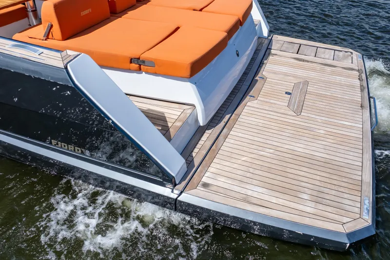  Yacht Photos Pics 2020 Fjord 44 Open yacht with orange seating and wooden deck on water.