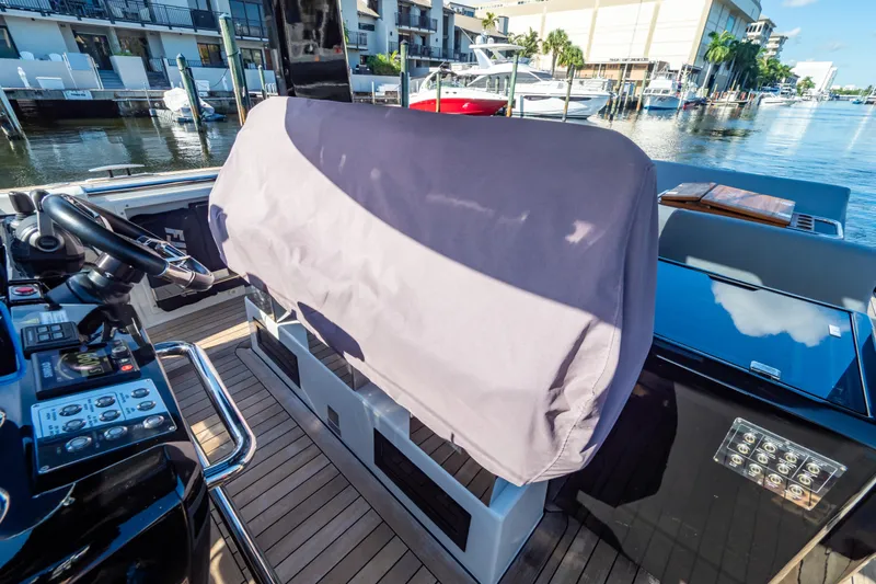  Yacht Photos Pics 2020 Fjord 44 Open yacht helm with covered controls, docked in a marina.