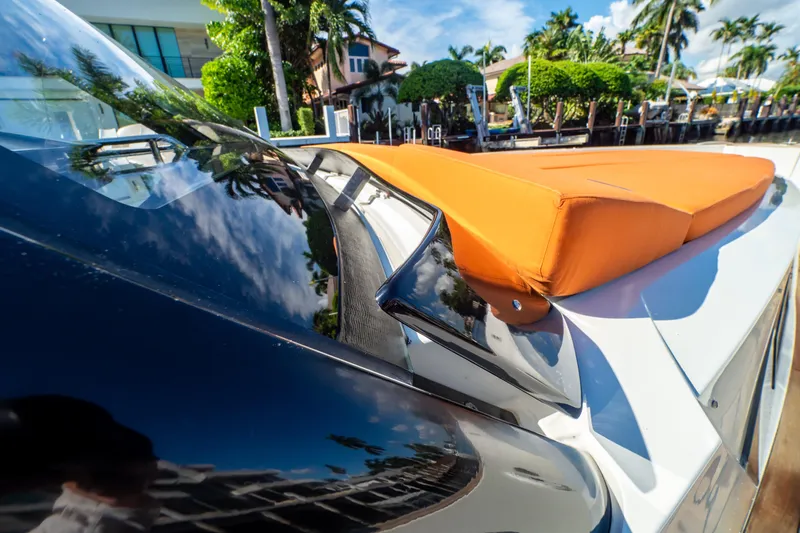  Yacht Photos Pics 2020 Fjord 44 Open yacht with orange cushions, docked in a tropical setting.