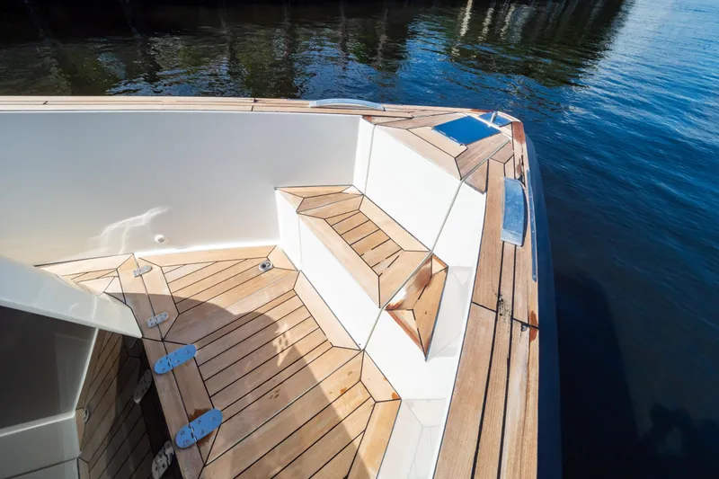  Yacht Photos Pics 2020 Fjord 44 Open boat with sleek wooden deck and seating area.