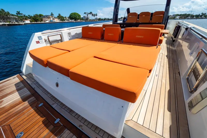  Yacht Photos Pics 2020 Fjord 44 Open yacht with orange sunbeds on deck, docked by the water.