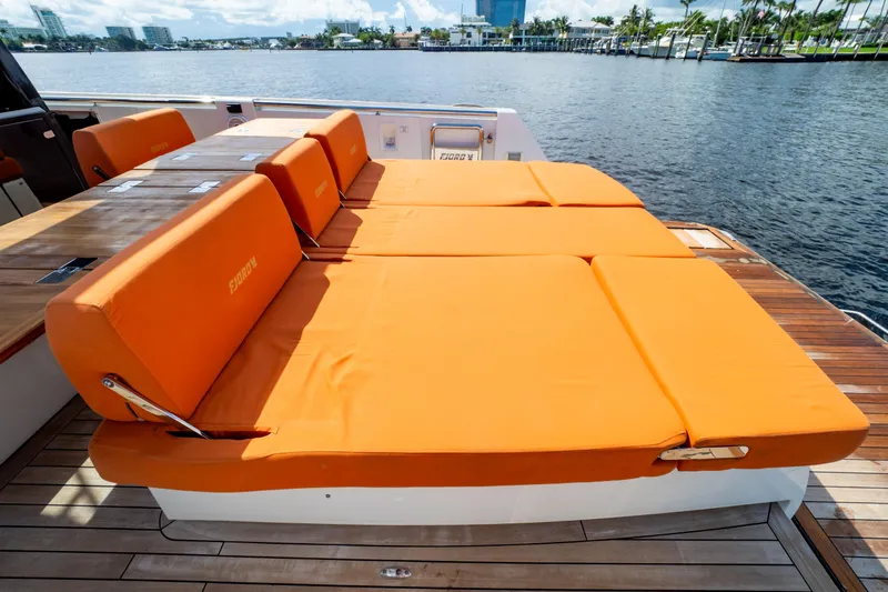  Yacht Photos Pics Luxury sunbed on 2020 Fjord 44 Open yacht with orange cushions by the water.