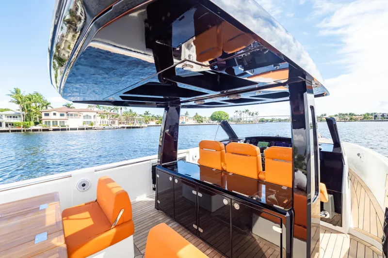  Yacht Photos Pics 2020 Fjord 44 Open yacht with sleek design, orange seating, and waterfront view.