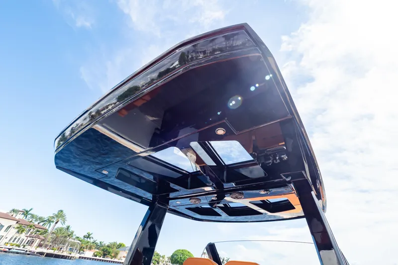  Yacht Photos Pics Fjord 44 Open 2020 boat canopy against blue sky, showcasing sleek design.