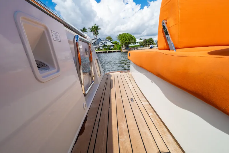  Yacht Photos Pics 2020 Fjord 44 Open yacht deck with orange seating and wooden flooring.