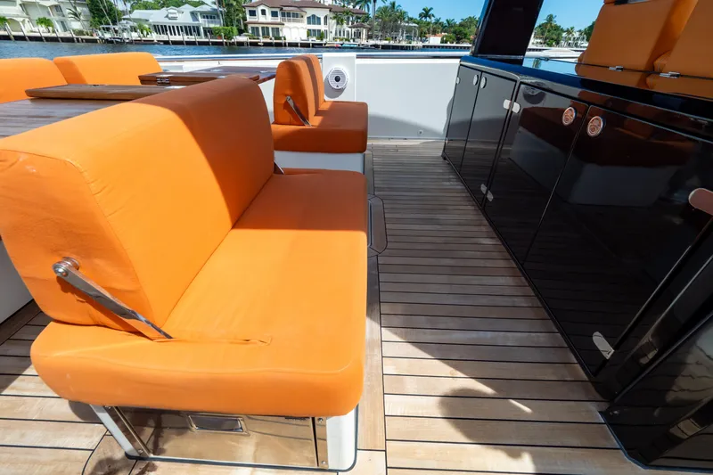  Yacht Photos Pics Orange seating on 2020 Fjord 44 Open yacht deck with wooden flooring.