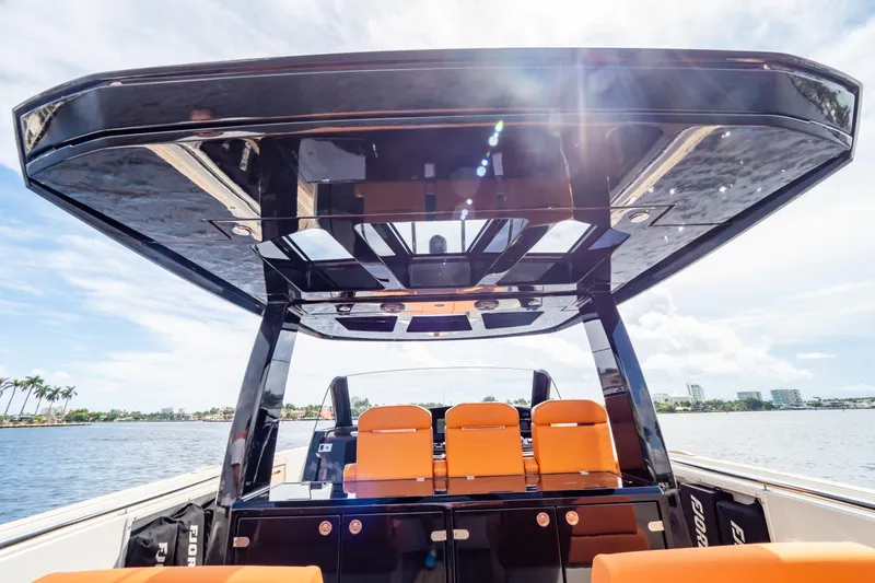  Yacht Photos Pics 2020 Fjord 44 Open boat with sleek design and vibrant orange seating on a sunny day.