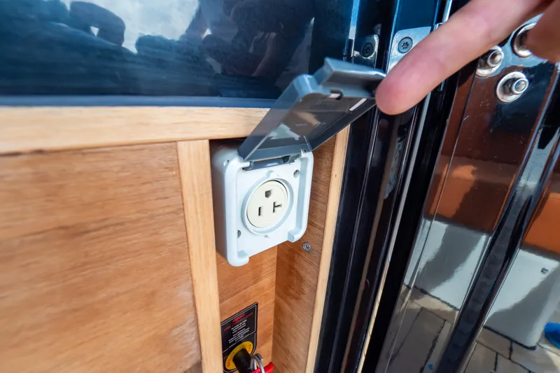  Yacht Photos Pics Power outlet on 2020 Fjord 44 Open yacht with protective cover being opened.