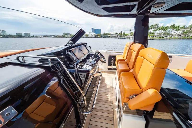  Yacht Photos Pics Luxurious 2020 Fjord 44 Open yacht interior with orange seating and modern helm.
