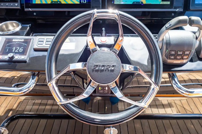  Yacht Photos Pics Steering wheel of 2020 Fjord 44 Open yacht with navigation controls.