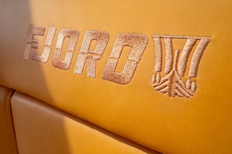  Yacht Photos Pics Embroidered Fjord logo on tan leather seat, 2020 Fjord 44 Open yacht.