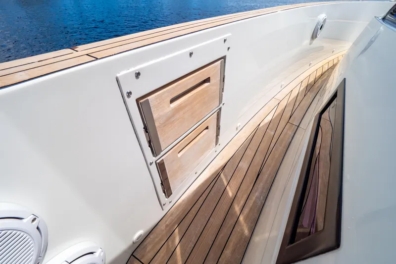  Yacht Photos Pics 2020 Fjord 44 Open yacht deck with wooden flooring and storage compartments.