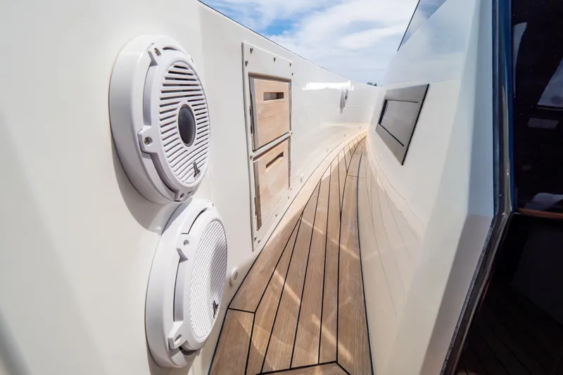  Yacht Photos Pics 2020 Fjord 44 Open yacht deck with speakers and wooden flooring.