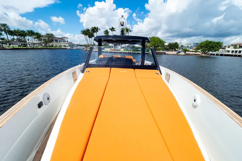  Yacht Photos Pics 2020 Fjord 44 Open yacht with orange deck, cruising on a scenic waterway.