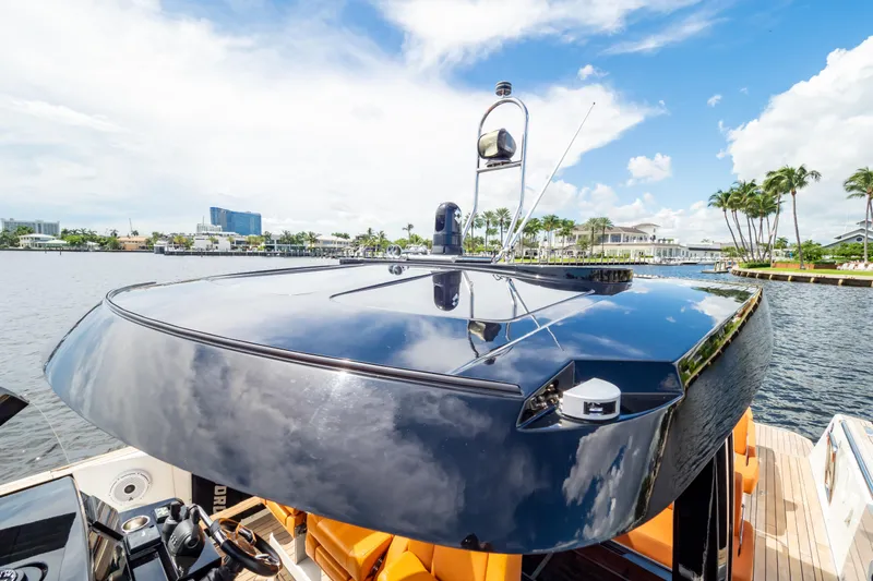  Yacht Photos Pics 2020 Fjord 44 Open yacht on a sunny day, reflecting blue sky and clouds.