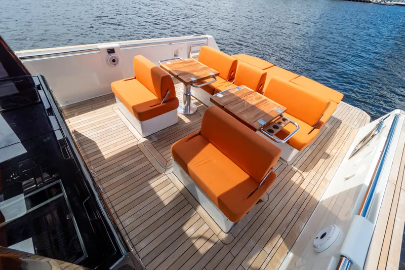  Yacht Photos Pics 2020 Fjord 44 Open yacht with orange seating and wooden deck, docked by the water.