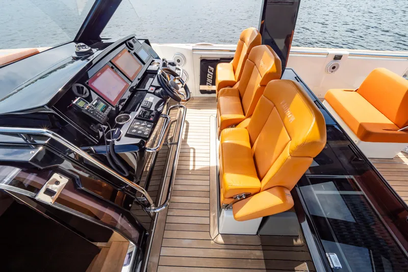  Yacht Photos Pics Luxurious 2020 Fjord 44 Open yacht cockpit with orange leather seats and modern controls.