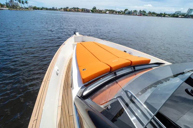  Yacht Photos Pics 2020 Fjord 44 Open yacht with orange sunbed on calm water.