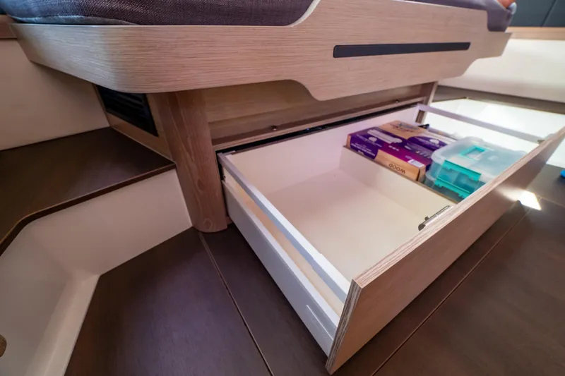  Yacht Photos Pics Under-seat storage drawer in 2020 Fjord 44 Open yacht, containing various items.