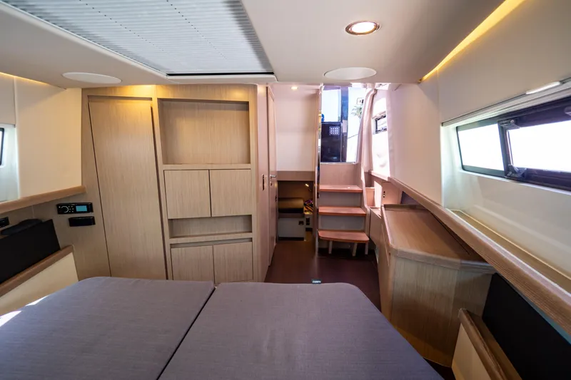  Yacht Photos Pics Interior of 2020 Fjord 44 Open yacht, featuring modern wood cabinetry and cozy sleeping area.