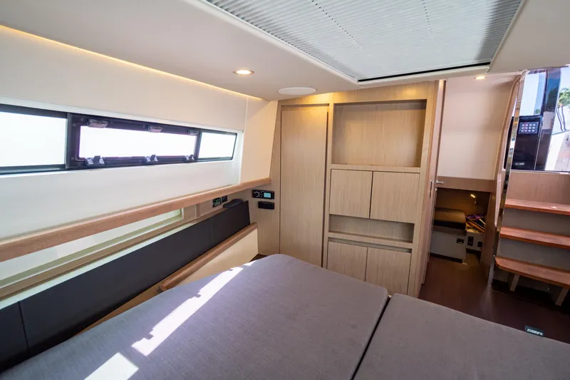  Yacht Photos Pics Luxurious interior of 2020 Fjord 44 Open yacht with modern wood finishes and ample natural light.