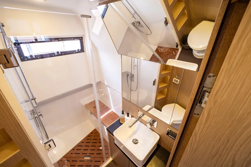  Yacht Photos Pics Modern bathroom interior of 2020 Fjord 44 Open yacht, featuring shower, sink, and toilet.