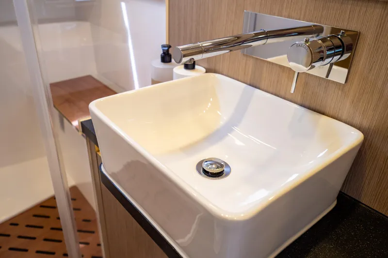  Yacht Photos Pics Modern bathroom sink on 2020 Fjord 44 Open yacht, featuring sleek design and chrome fixtures.