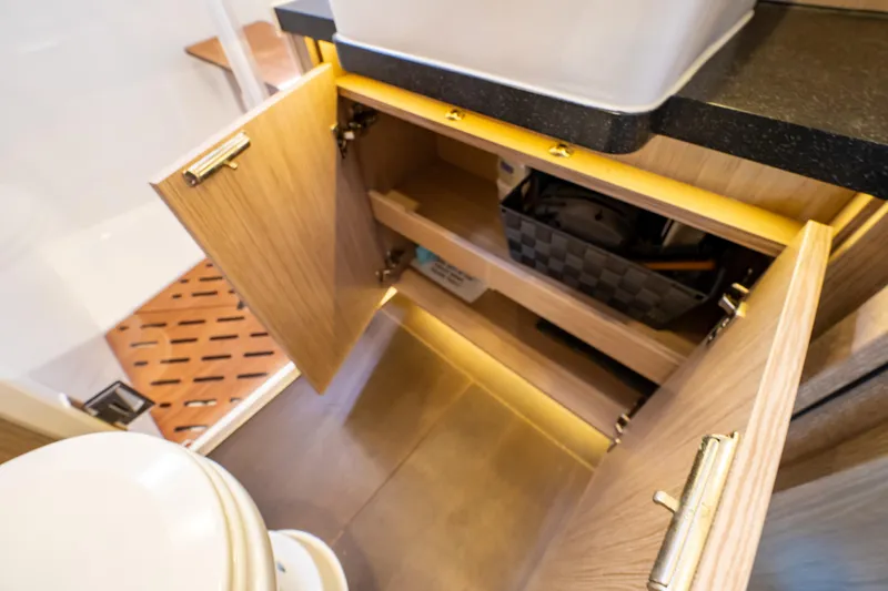  Yacht Photos Pics Interior of 2020 Fjord 44 Open yacht bathroom with open wooden cabinet.