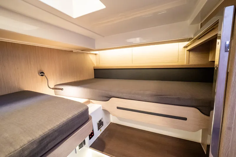 Yacht Photos Pics 2020 Fjord 44 Open cabin interior with modern wooden design and cozy sleeping area.