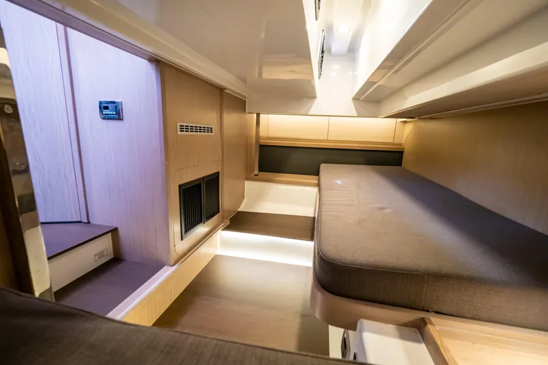  Yacht Photos Pics Interior of 2020 Fjord 44 Open yacht, featuring modern wood finishes and cozy sleeping area.