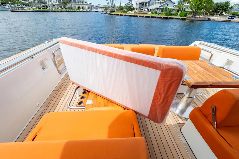  Yacht Photos Pics 2020 Fjord 44 Open yacht with orange seating and wooden deck by the water.