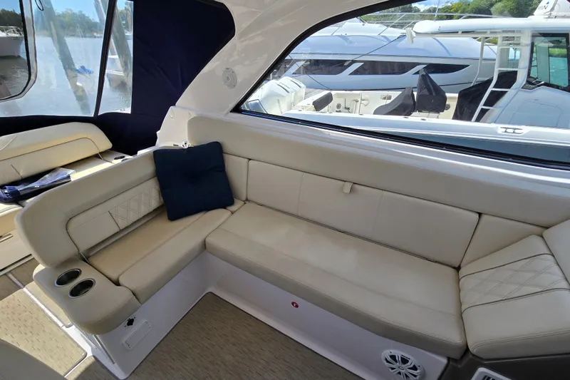  Yacht Photos Pics Luxurious interior of 2018 Regal 35 Sport Coupe with beige seating and blue cushion.