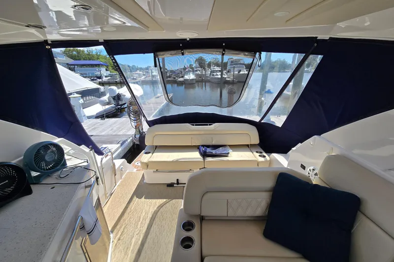  Yacht Photos Pics Interior of 2018 Regal 35 Sport Coupe yacht with seating and marina view.