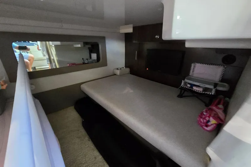  Yacht Photos Pics 2018 Regal 35 Sport Coupe interior cabin with bed, TV, and storage.